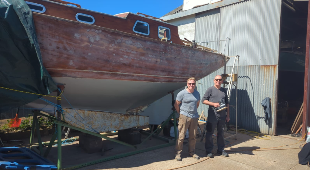 The Sailhaven CIC team pictured with the yacht.